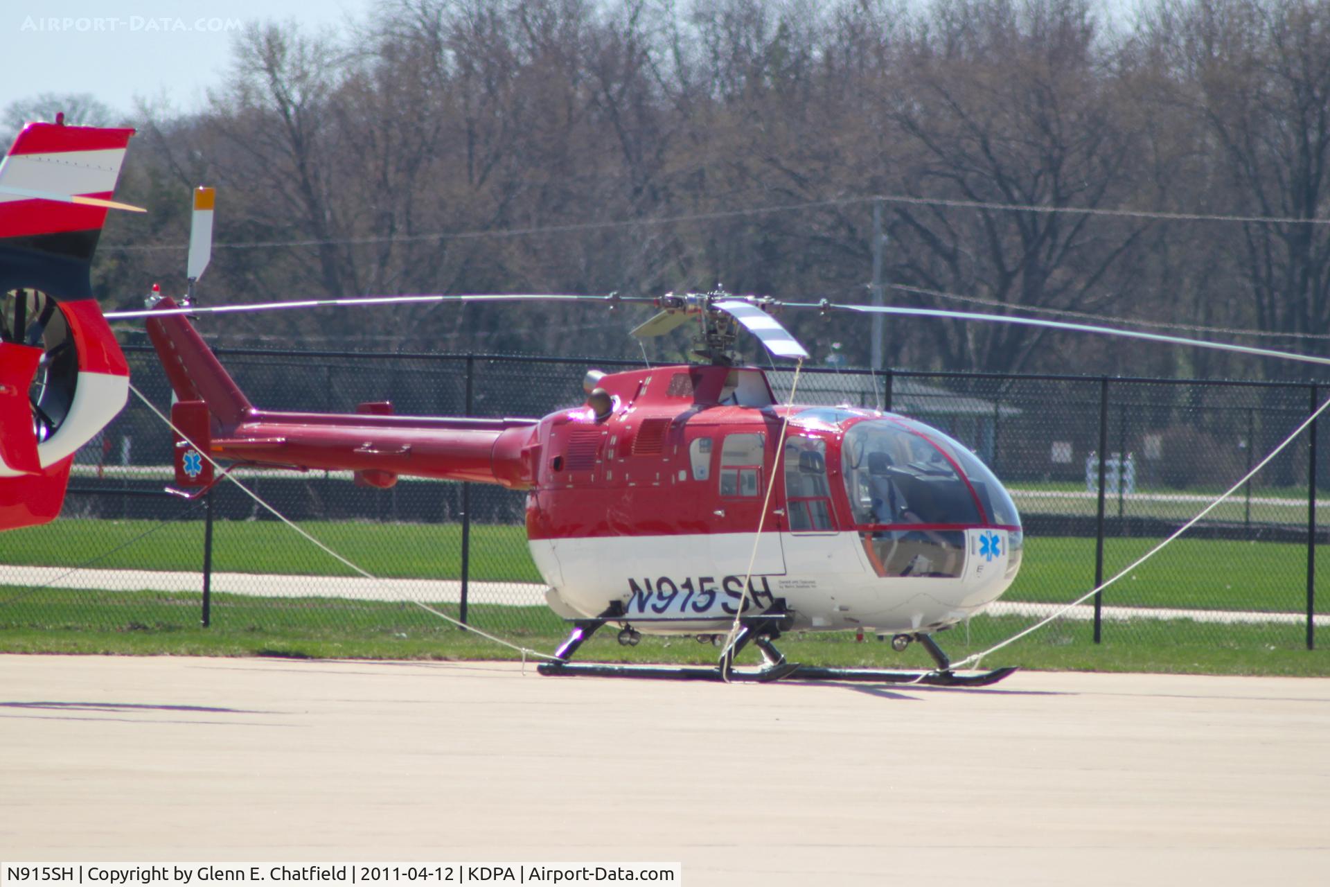 N915SH, 1977 MBB Bo-105S C/N S-340, Photographed through a chain-link fence.