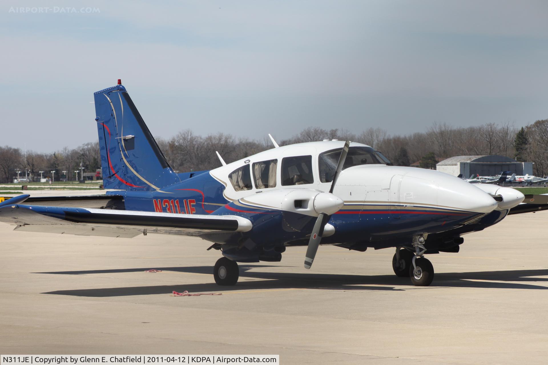 N311JE, Piper PA-23-250 C/N 27-7754053, On the east ramp.  Photographed through a chain-link fence.