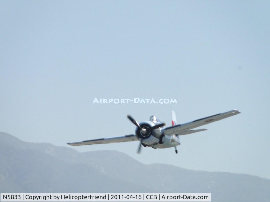 N5833, 1945 General Motors (Grumman) FM-2 Wildcat C/N 5833, Making a wheel up pass while Navion N91707 taxi's off the runway