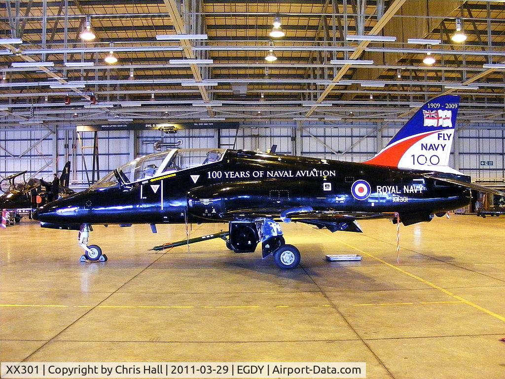 XX301, 1980 Hawker Siddeley Hawk T.1A C/N 134/312126, inside the FRADU Hawk hangar, wearing RN titles and 'Fly Navy' tail art