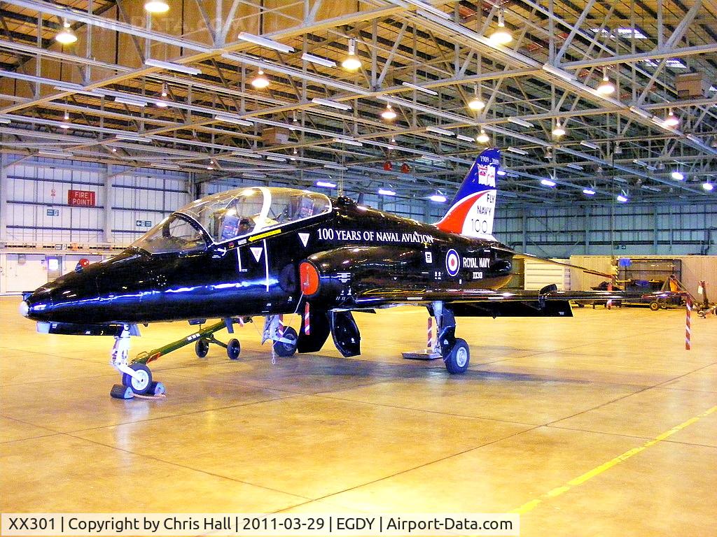 XX301, 1980 Hawker Siddeley Hawk T.1A C/N 134/312126, inside the FRADU Hawk hangar, wearing RN titles and 'Fly Navy' tail art