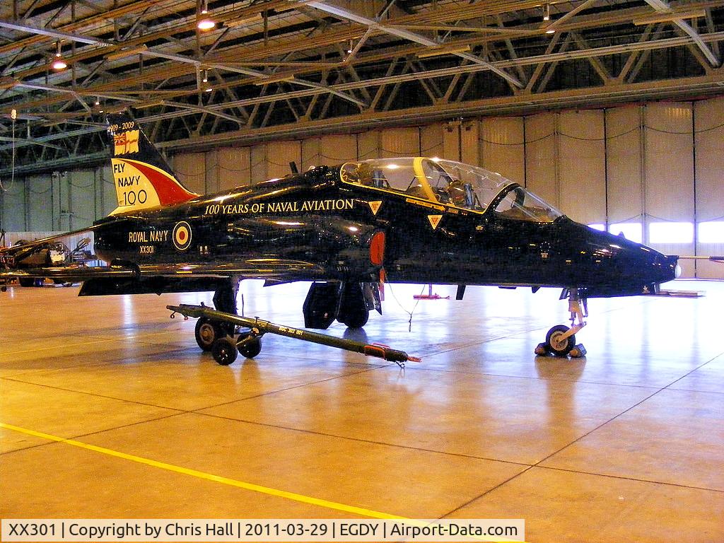 XX301, 1980 Hawker Siddeley Hawk T.1A C/N 134/312126, inside the FRADU Hawk hangar, wearing RN titles and 'Fly Navy' tail art