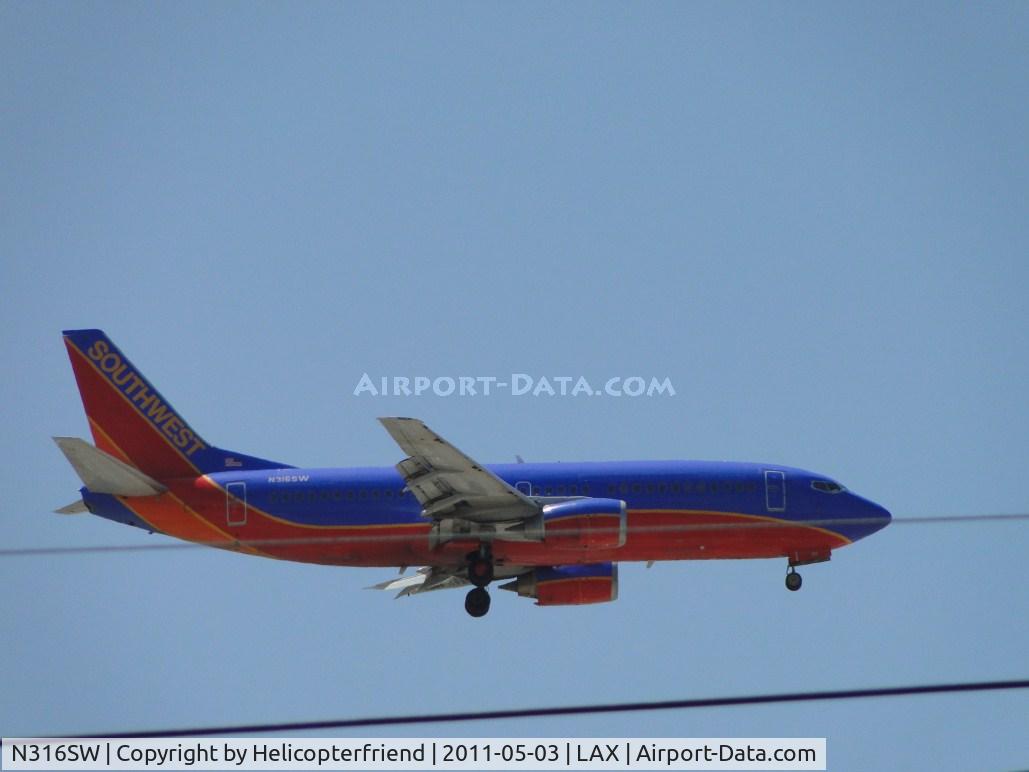 N316SW, 1986 Boeing 737-3H4 C/N 23338, 1/2 miles east of LAX on final to runway 24