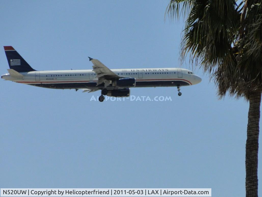 N520UW, 2009 Airbus A321-231 C/N 3924, 1/2 miles east of LAX on final to runway 24, ready to pass south of the trees
