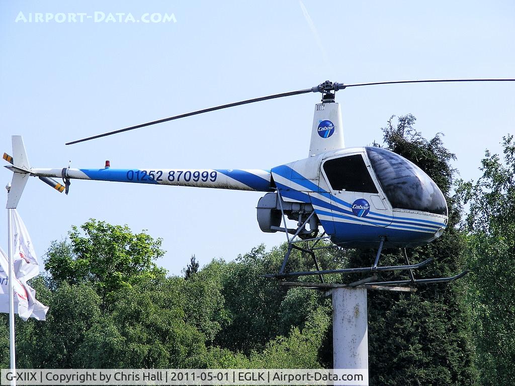 G-XIIX, 1988 Robinson R22 Beta C/N 0736, damaged in an accident at Blackpool Airport 16th November 1995, now at the entrance to Blackbushe Airport, believed to have been rebuilt using parts from several other R22's