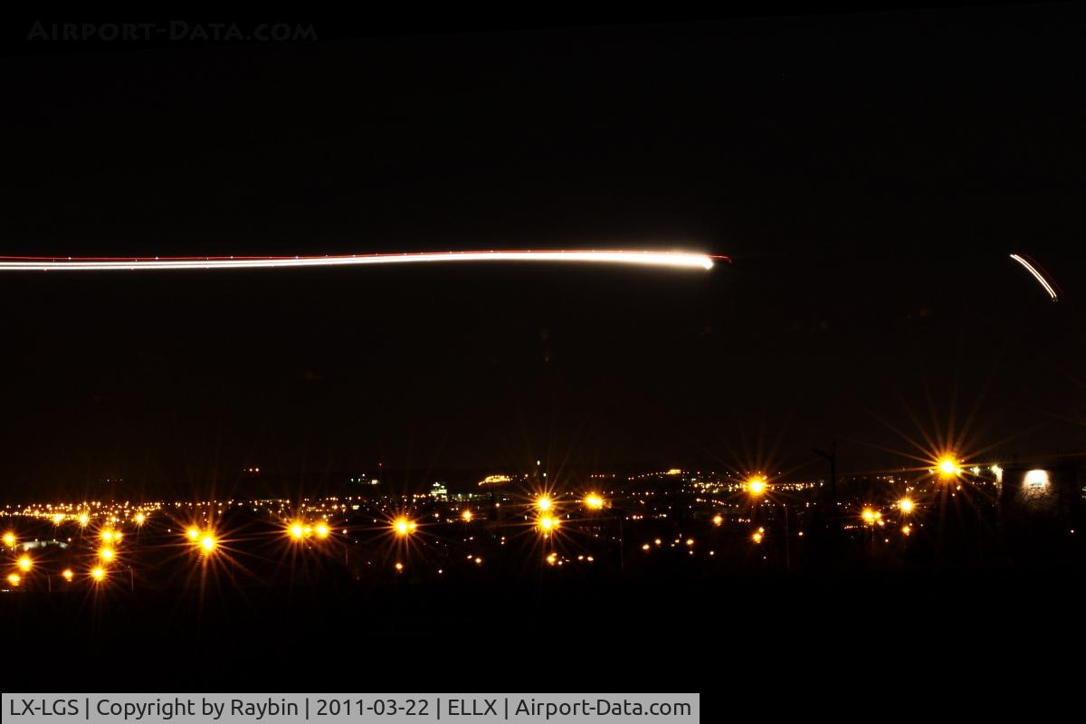 LX-LGS, 2005 Boeing 737-7C9 C/N 33956, Night arrival rwy 06, with the lights of Luxembourg-city and a Luxair EMB-145 in the background