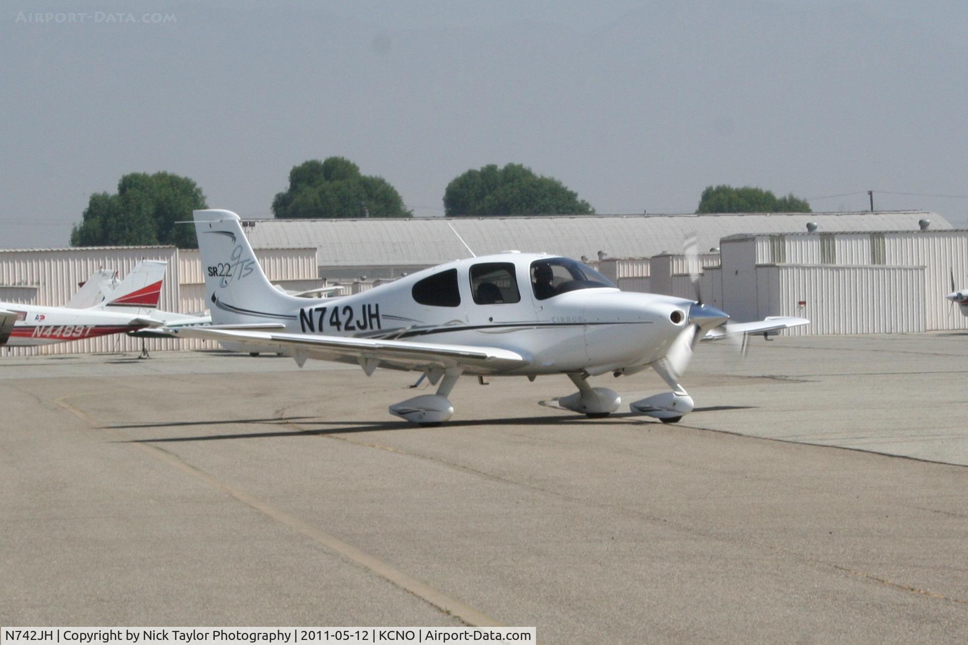 N742JH, 2006 Cirrus SR22 GTS C/N 1963, Holding short of Twy Juliet as we taxi past.