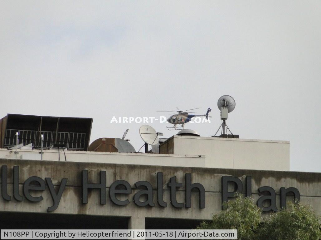 N108PP, 2008 MD Helicopters 369E C/N 0578E, Appears to being landing on the building but is north and starting final for landing in the street, near landing area old 99L