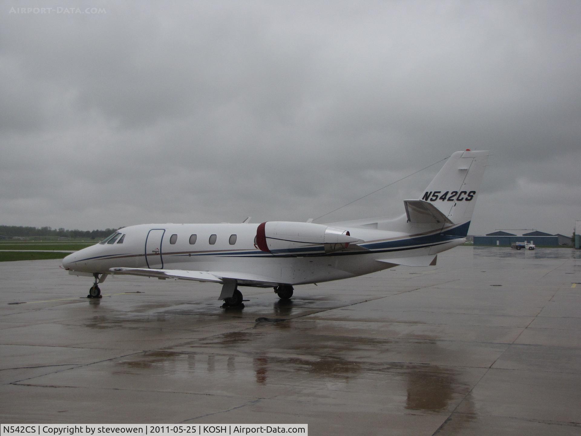 N542CS, 2004 Cessna 560XL C/N 560-5523, On a wet and windy Orion FBO ramp @ KOSH