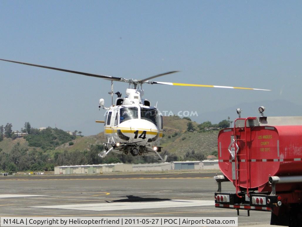 N14LA, 2005 Bell 412EP C/N 36393, Hovering over to the pad and fuel truck for re-fueling