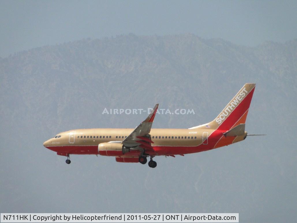 N711HK, 1998 Boeing 737-7H4 C/N 27845, Named for a co-founder and one of the few still in the original color scheme, on final to runway 26R