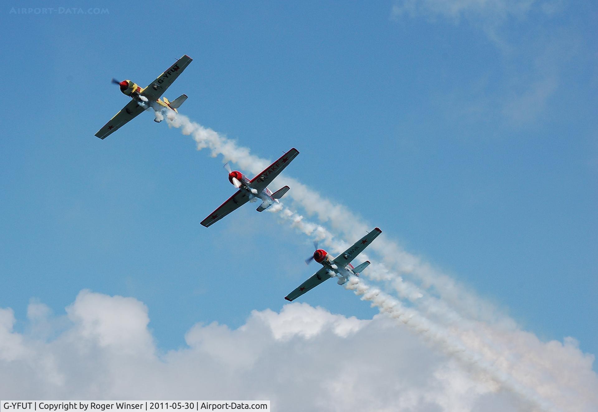 G-YFUT, 1988 Bacau Yak-52 C/N 888410, Off airport. Leading Team Osprey over Swansea Bay during the 2011 Mumbles Navy Days display, Swansea, Wales, UK