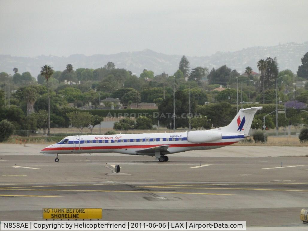 N858AE, 2003 Embraer ERJ-140LR (EMB-135KL) C/N 145754, Standing by in the center taxiway waiting to enter runway 24L
