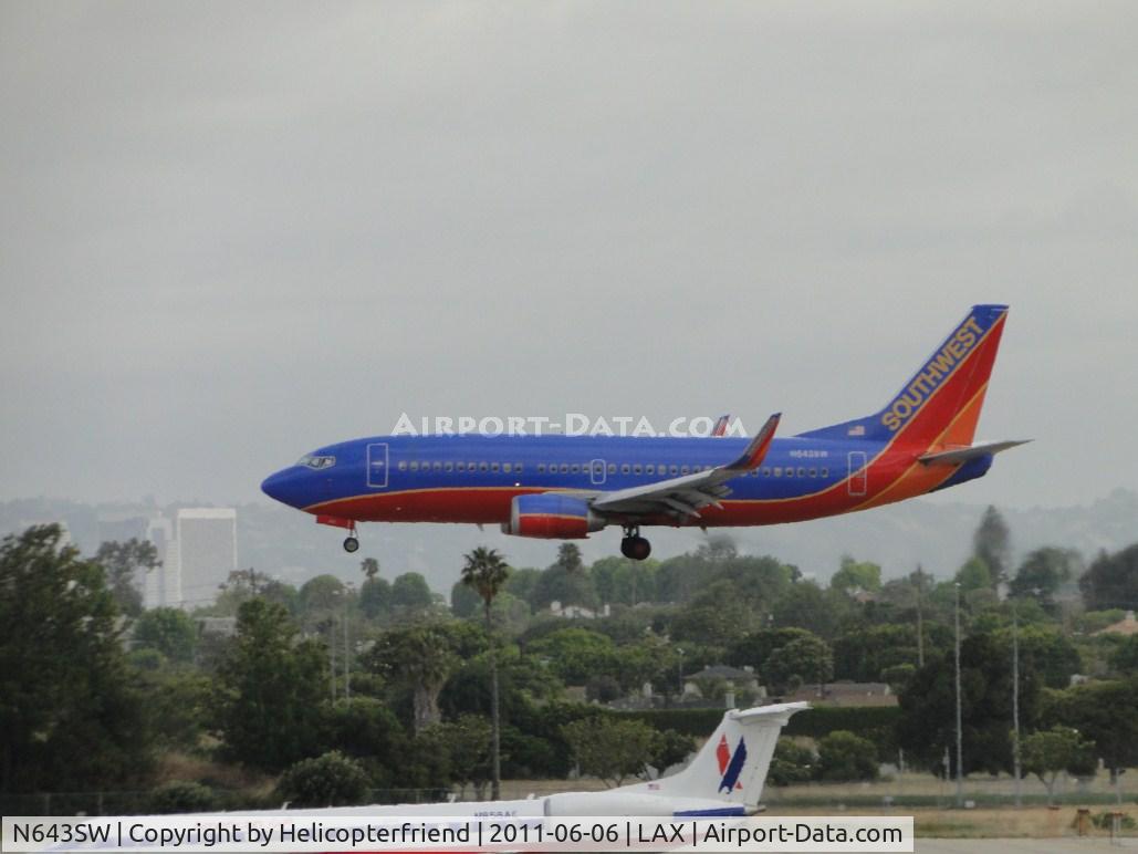 N643SW, 1997 Boeing 737-3H4 C/N 27716, Landing on runway 24R and passing American Eagle N858AE