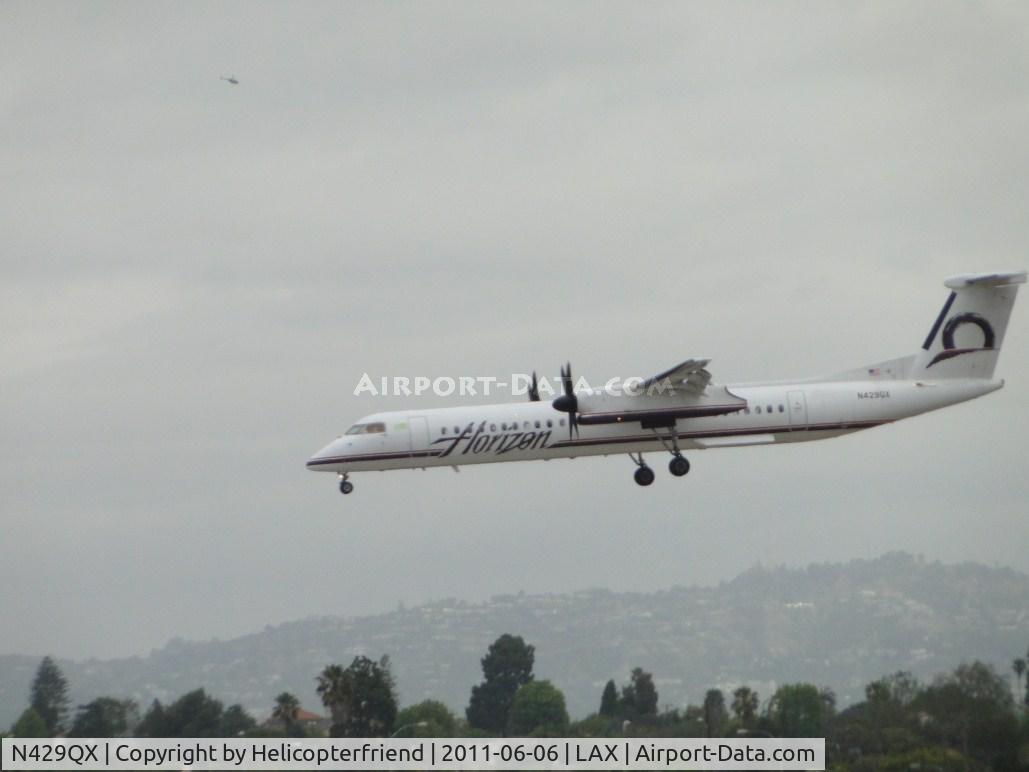 N429QX, 2007 De Havilland Canada DHC-8-402 Dash 8 C/N 4161, While landing on runway 24R, tried to capture helicopter in upper left corner
