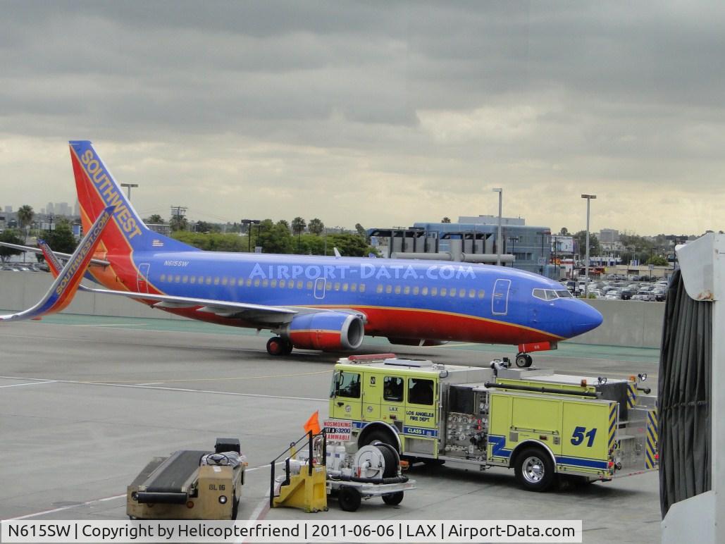 N615SW, 1995 Boeing 737-3H4 C/N 27698, Stopped before turning into terminal 3 to wait for fire truck to pass