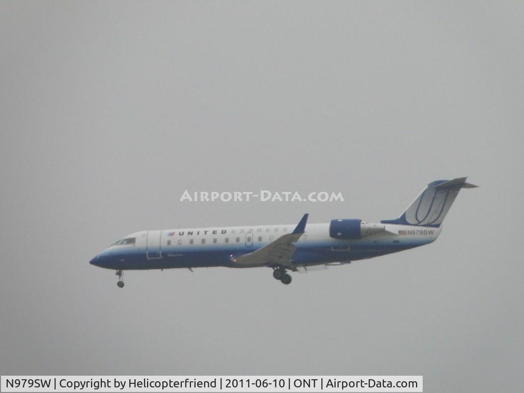 N979SW, 2004 Bombardier CRJ-200ER (CL-600-2B19) C/N 7954, United Express flown by Sky West on final to runway 26R during a very hazy morning