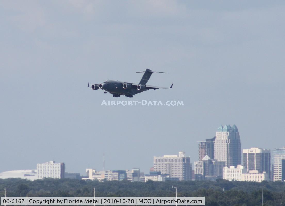 06-6162, 2006 Boeing C-17A Globemaster III C/N P-162, C-17 on approach into MCO with downtown Orlando in background