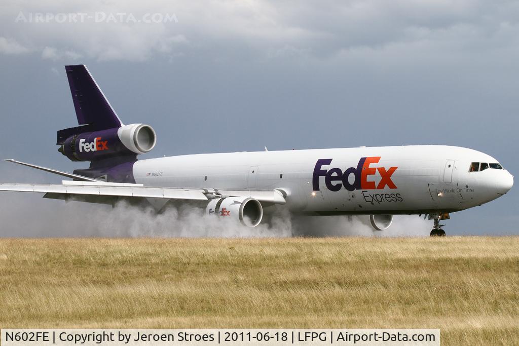 N602FE, 1990 McDonnell Douglas MD-11F C/N 48402, wet runways are the best