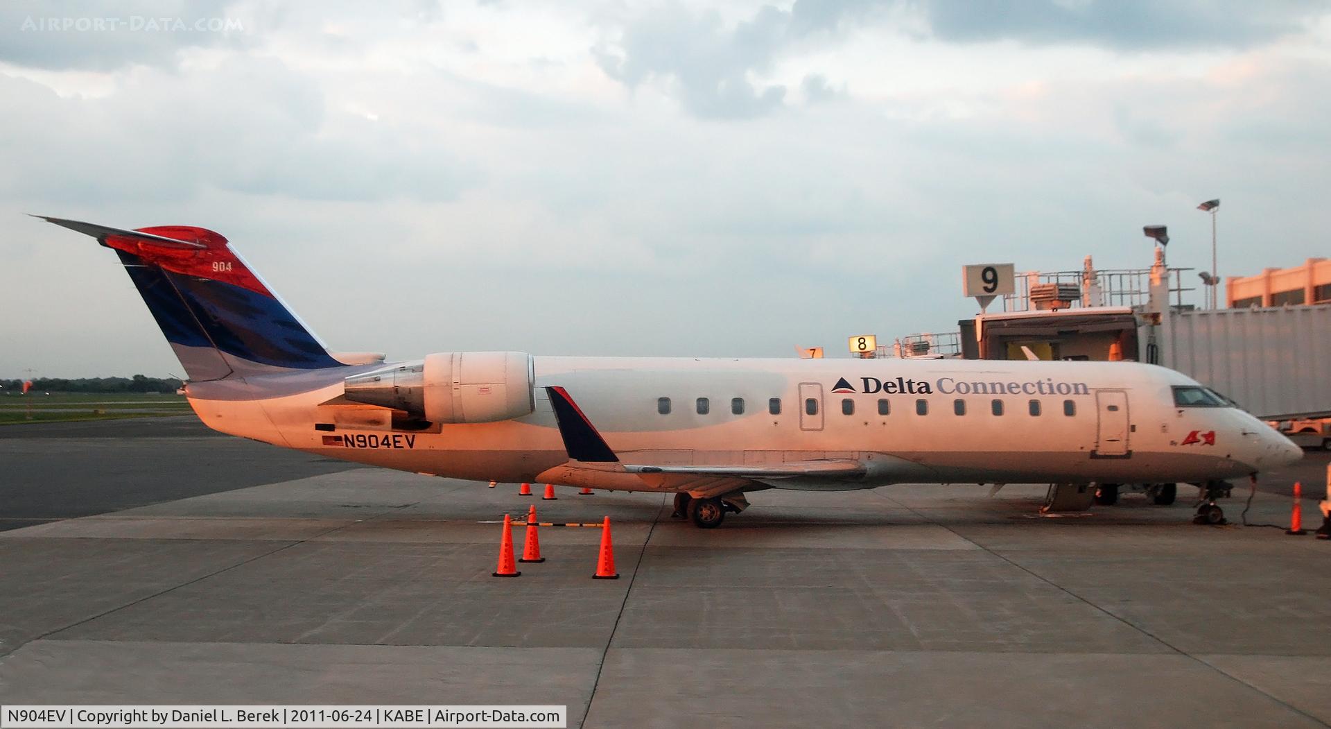 N904EV, 2002 Bombardier CRJ-200ER (CL-600-2B19) C/N 7628, The sun sets on an ASA CRJ as it sits forlornly awaiting mechanical attention.  The flight was supposed to leave for Atlanta at 5 p.m. but was not due to take off for at least another 5 hours.