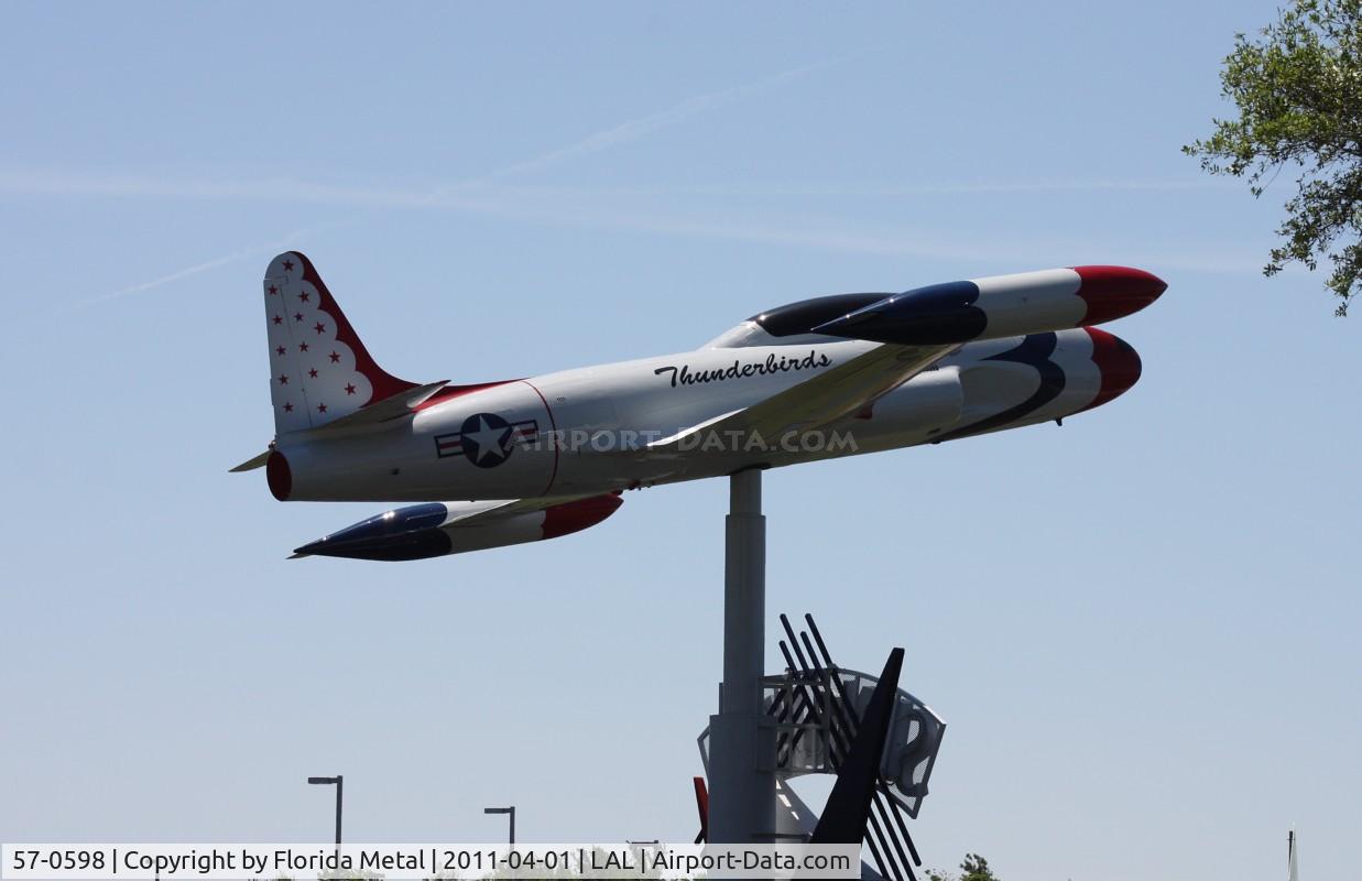 57-0598, 1957 Lockheed T-33A Shooting Star C/N 580-1247, T-33 on a pole in Thunderbirds colors at a School next to Florida Aviation museum