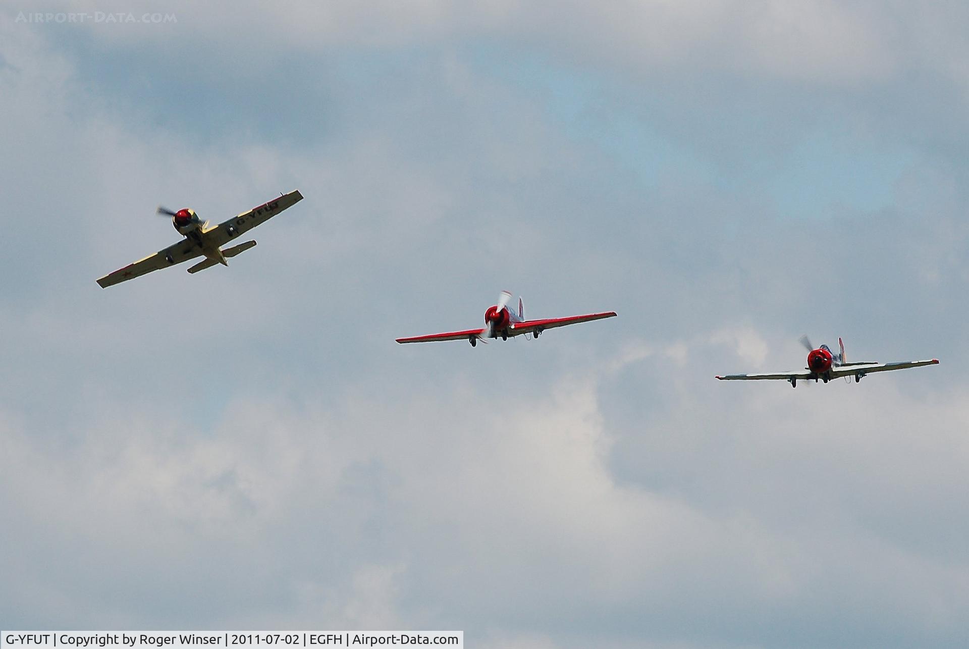 G-YFUT, 1988 Bacau Yak-52 C/N 888410, Leading Team Osprey in a run and break after formation aerobatics practice.