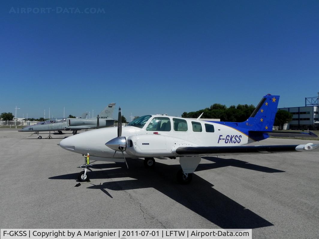 F-GKSS, 1971 Beech 58 Baron C/N TH-154, On the South Apron, next to a  Russian Albatros used for joy flights in the region. July 1, 2011 was the last day of French Air Force squadron in Nimes and flights had to come in before 0730Z, when the ceremony started. LFTW now a 100% civil Airport