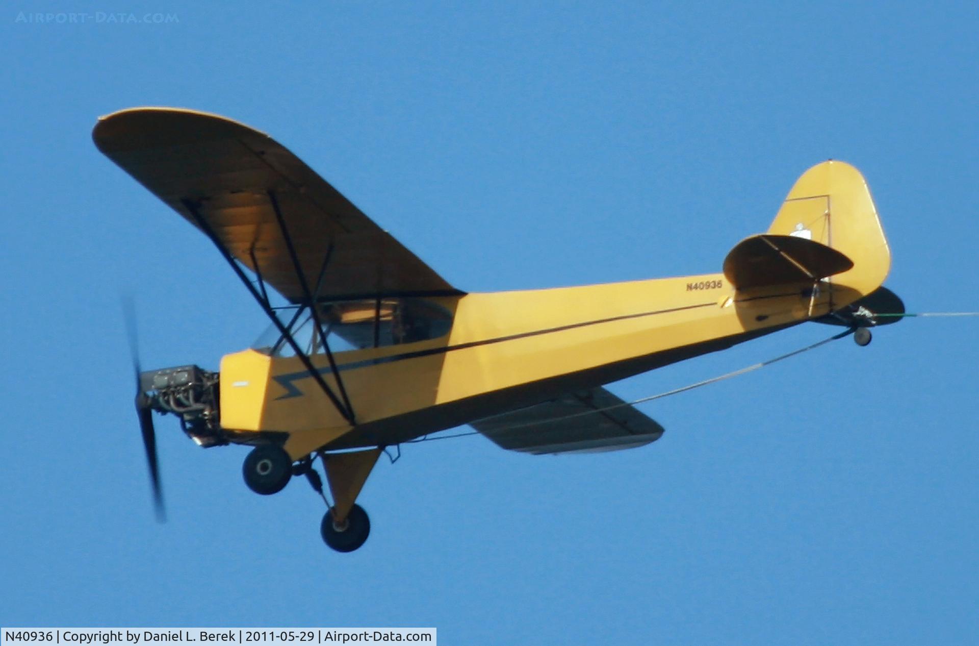 N40936, 1941 Piper J3C-65 Cub C/N 7592, Hard to believe, but this 70-year-old airplane is still hard at work towing banners, as seen over Point Pleasant Beach, NJ.