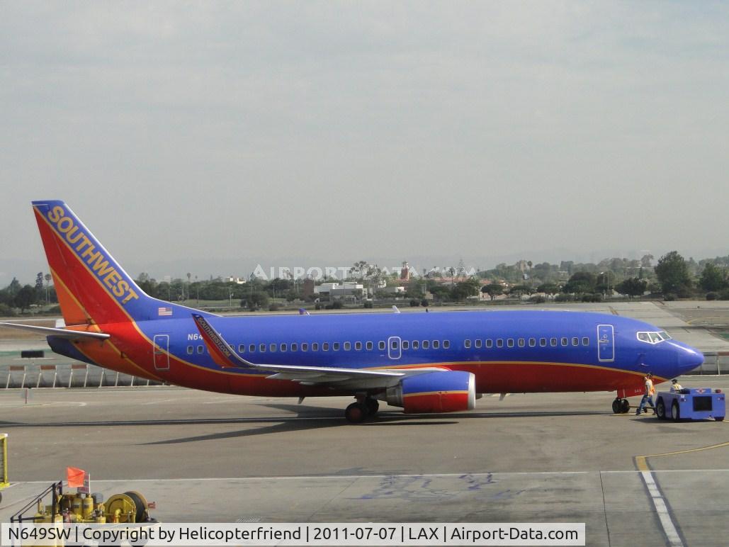 N649SW, 1997 Boeing 737-3H4 C/N 27719, Just pushed back from terminal 14, starting engines