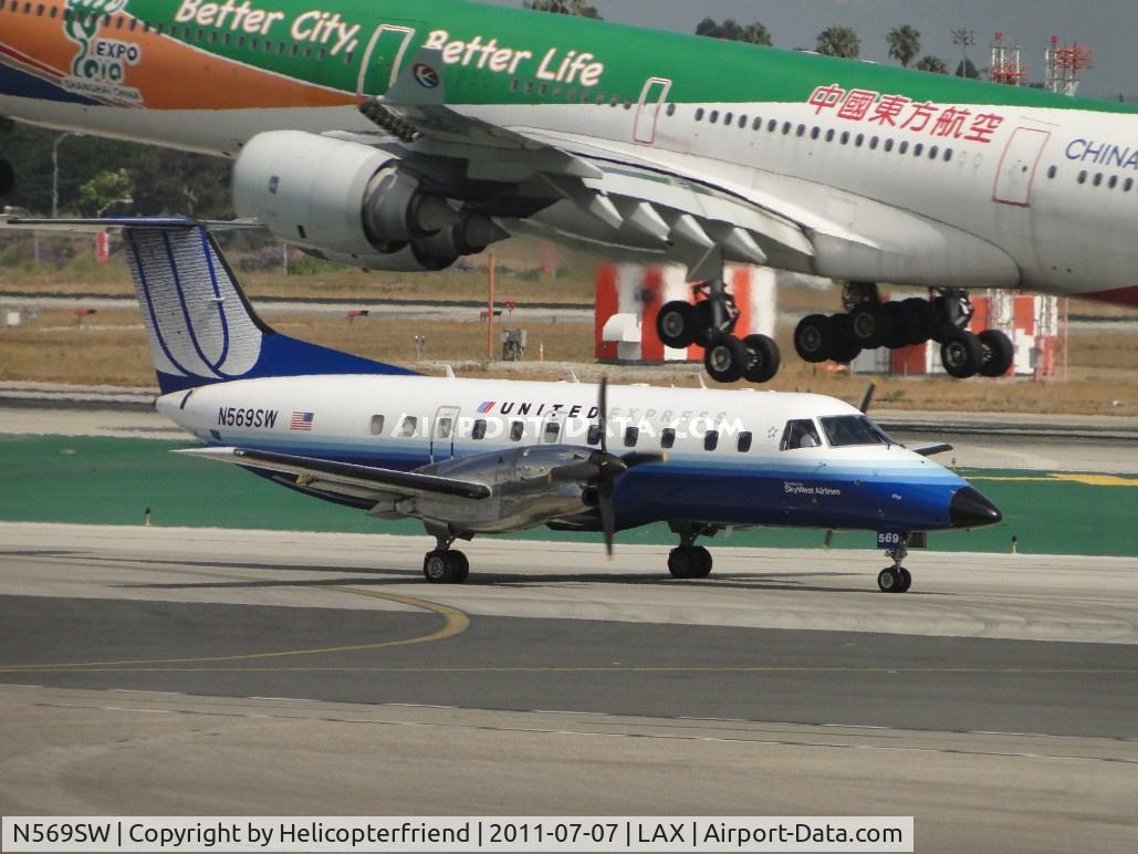 N569SW, 1998 Embraer EMB-120ER Brasilia C/N 120344, Taxiing to runway 24L while 747 landing on runway 24R