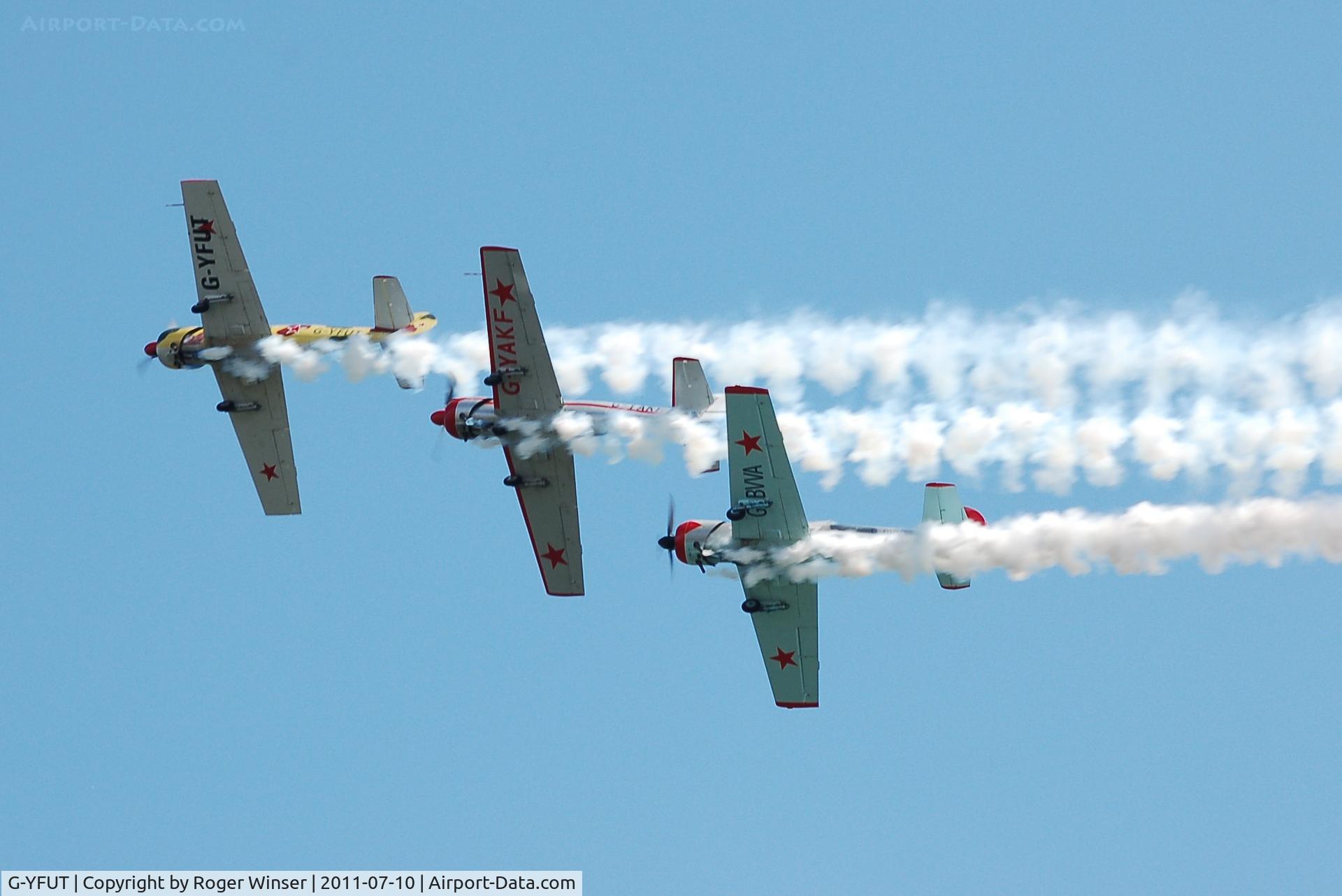 G-YFUT, 1988 Bacau Yak-52 C/N 888410, Off airport. Leading Team Osprey. Displaying at the 2011 Wales National Airshow, Swansea Bay, Wales, UK.
