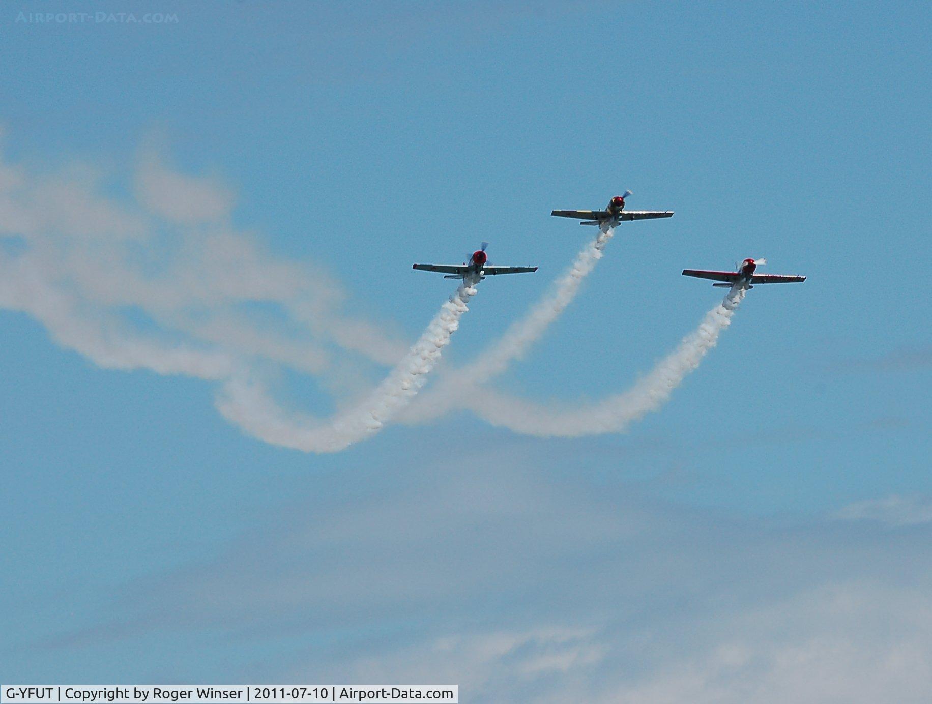 G-YFUT, 1988 Bacau Yak-52 C/N 888410, Off airport. Leading Team Osprey. Displaying at the 2011 Wales National Airshow, Swansea Bay, Wales, UK.