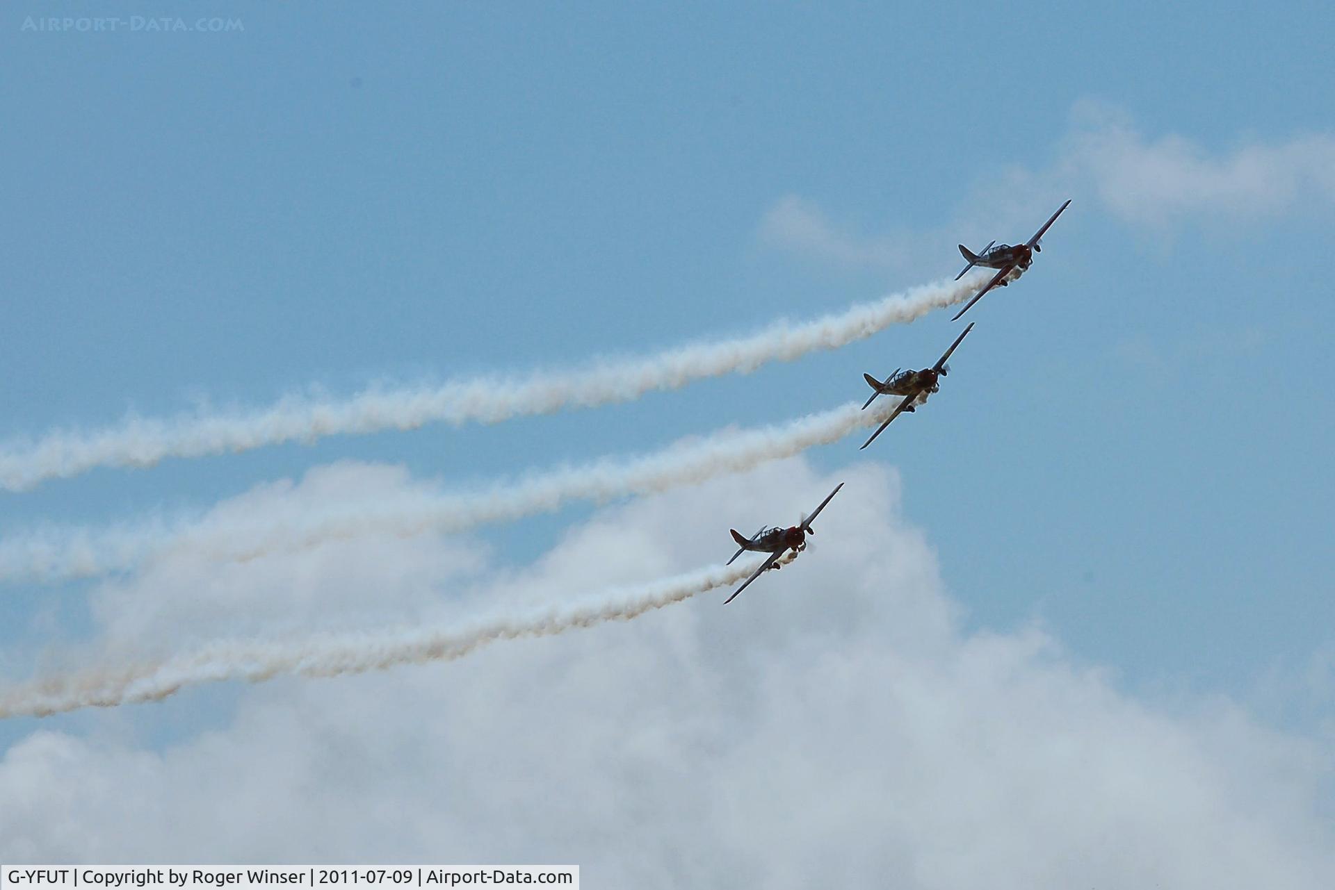 G-YFUT, 1988 Bacau Yak-52 C/N 888410, Off airport. Leading Team Osprey at the 2011 Wales National Airshow, Swansea Bay, Wales, UK.