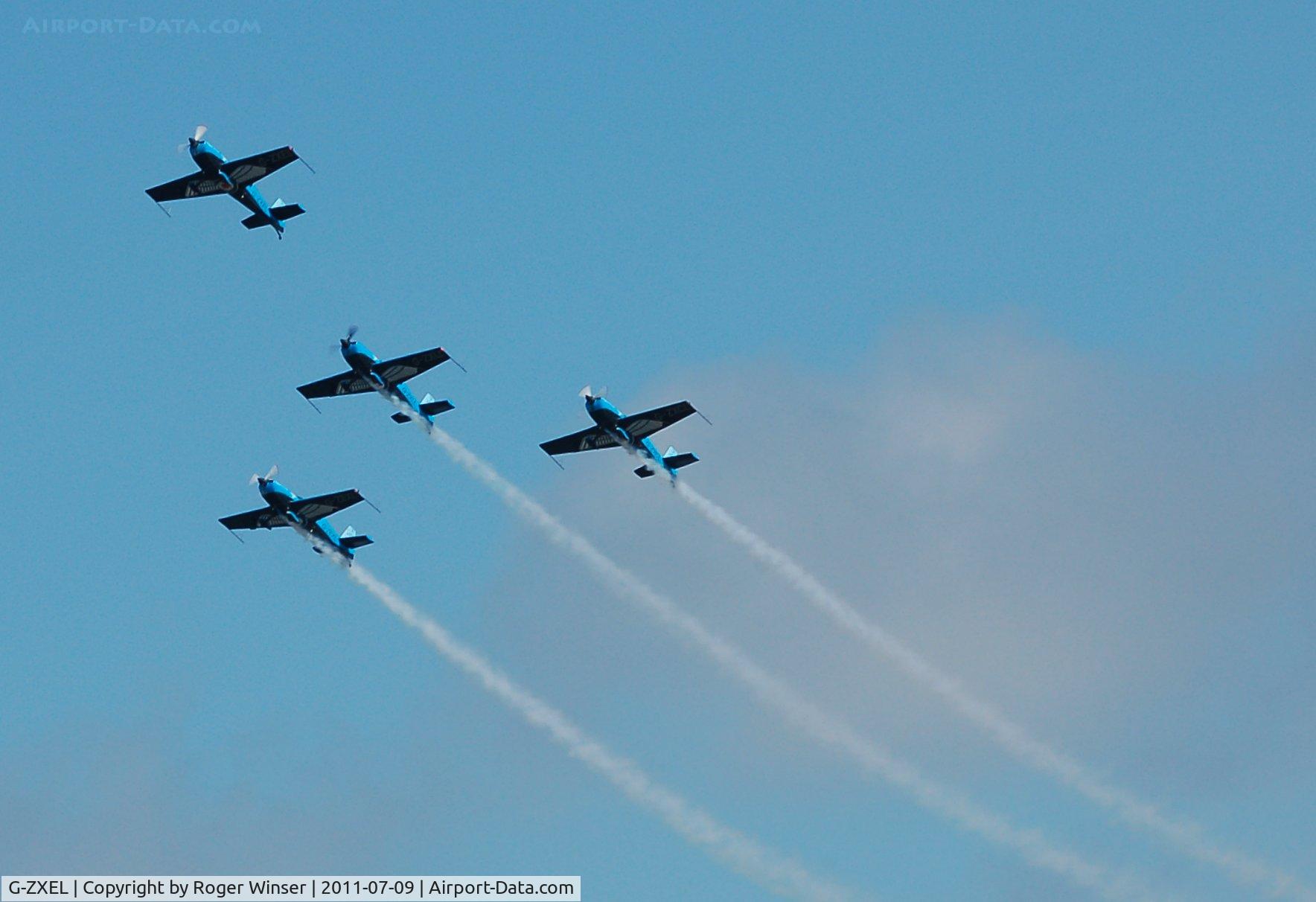 G-ZXEL, 2006 Extra EA-300L C/N 1224, Off airport. Leading The Blades aerobatic display team in swan formation at the Wales National Airshow, Swansea Bay, Wales, UK.