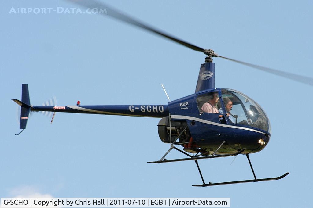 G-SCHO, 2005 Robinson R22 Beta II C/N 3833, being used for ferrying race fans to the British F1 Grand Prix at Silverstone