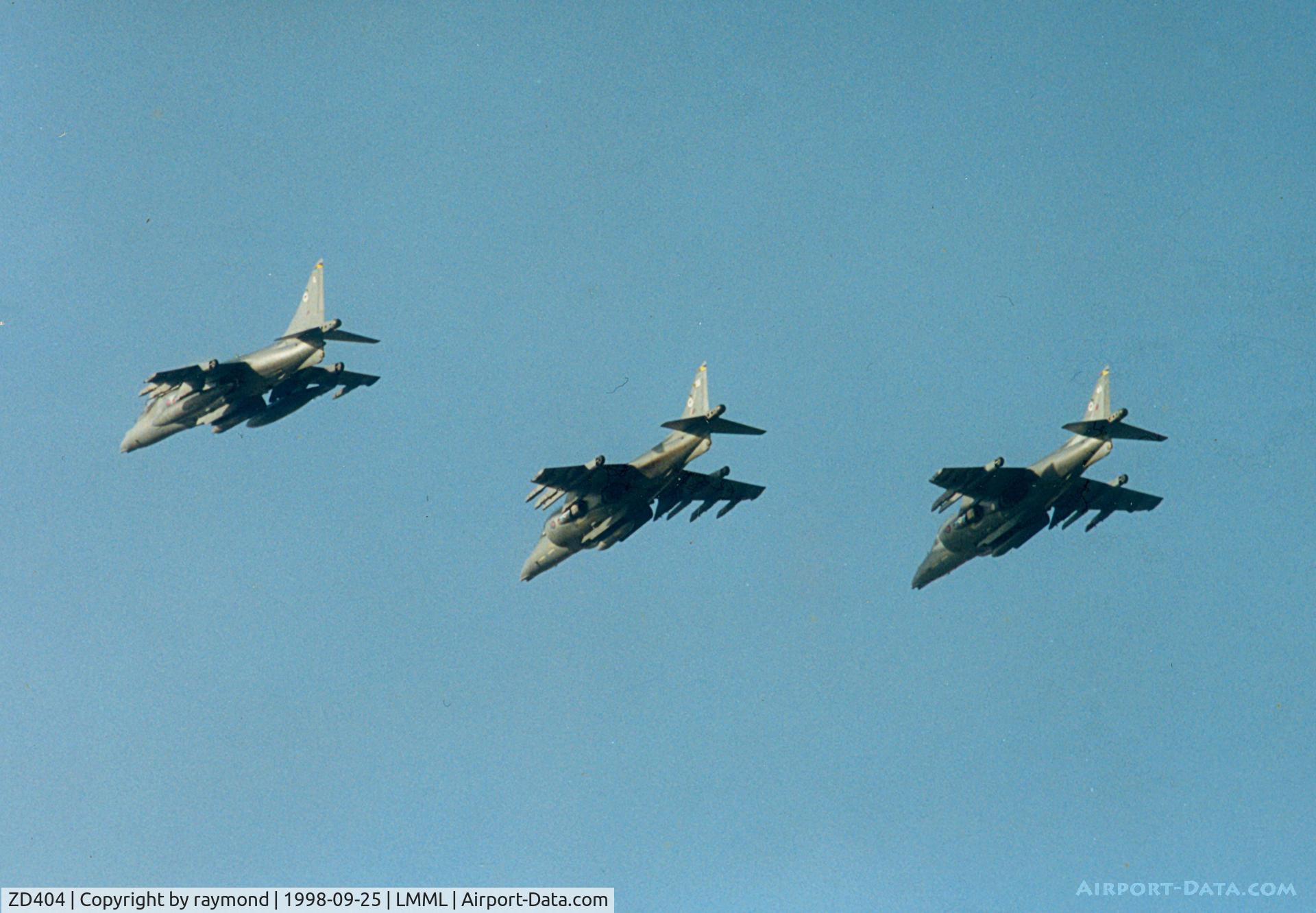 ZD404, 1988 British Aerospace Harrier GR.7 C/N P33, The arrival of 3 Harriers 2GR7s and 1 T10 was very welcomed for the Malta International Airshow1998. This picture shows 2 GR7s ZD404/33, ZD433/45 and and T10 ZH663/Q of 20Sqd RAF on the run in and break on their arrival.