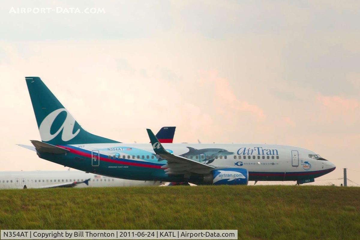 N354AT, 2009 Boeing 737-7BD C/N 36725, An AirTran B737-7BD in Georgia Aquarium Dolphin livery taxis into position for take off on runway 27R @ Atlanta's Hartsfield-Jackson International Airport. (an f-stop 5.6 photograph)