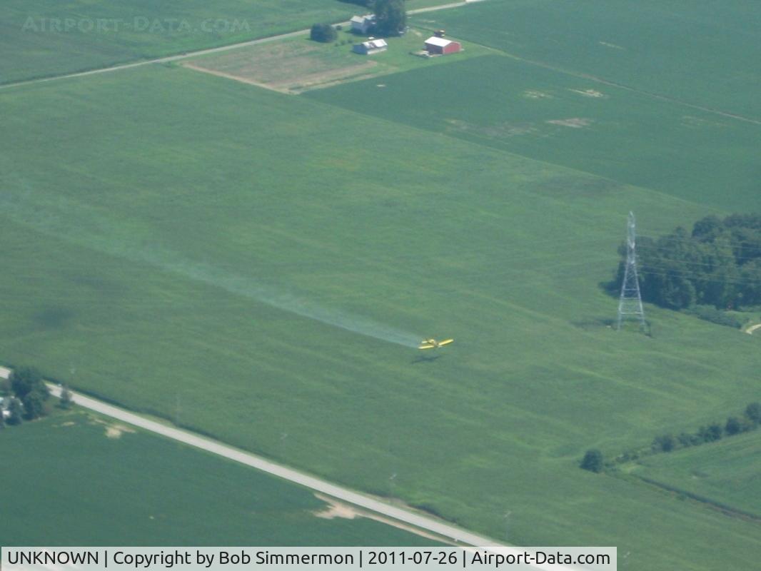 UNKNOWN, Miscellaneous Various C/N unknown, Crop duster flying under power lines in northern Indiana.