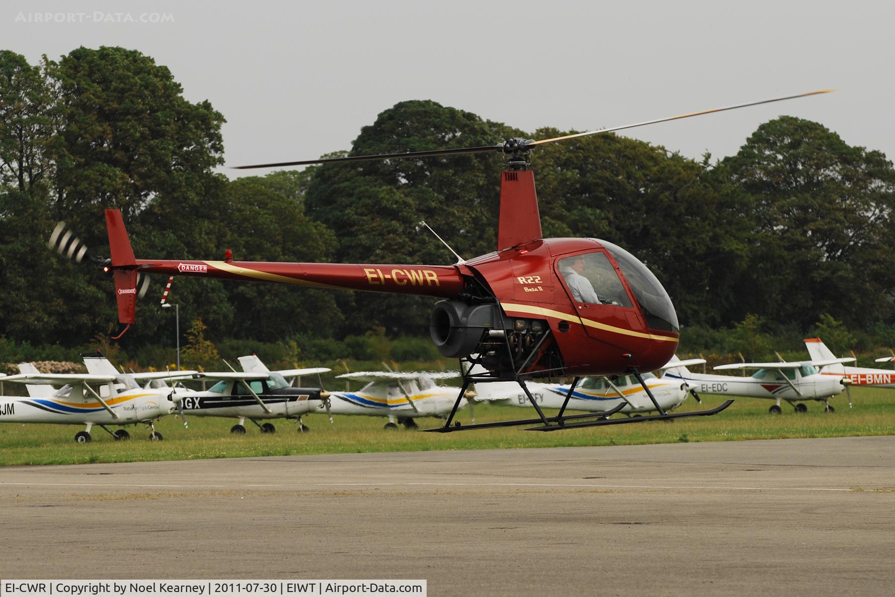 EI-CWR, 2001 Robinson R22 Beta II C/N 3234, Lifting off from the apron at Weston.