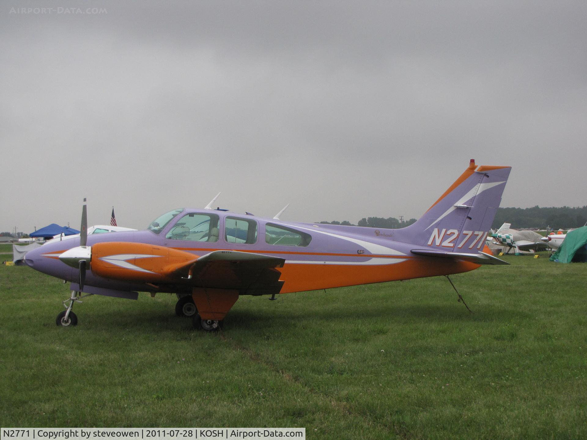 N2771, 1962 Beech 95-A55 Baron C/N TC-270, colourful addition to a gray day @ EAA2011
