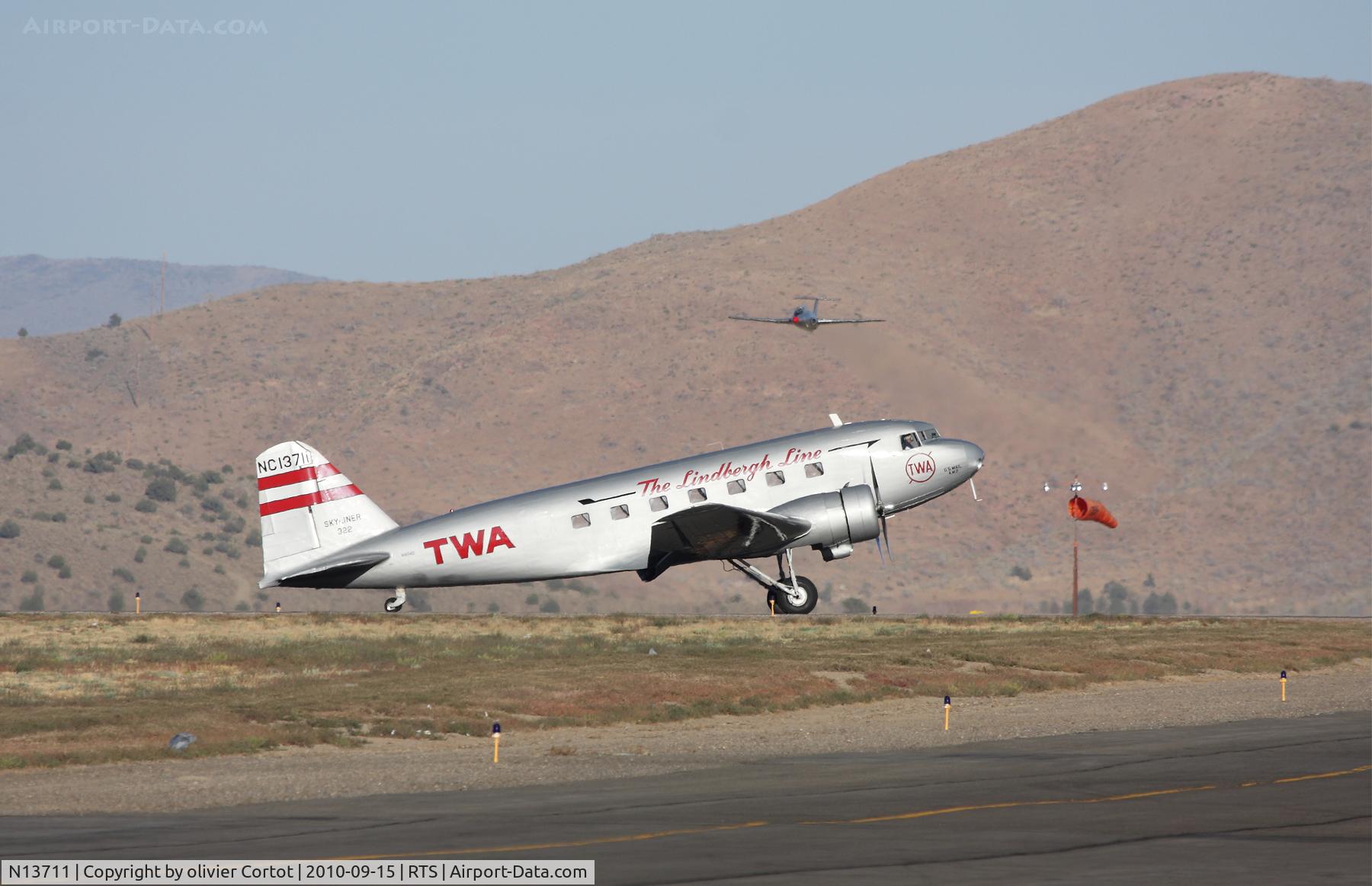 N13711, 1935 Douglas DC-2-118B C/N 1368, in the heat of reno. Note the L-29 in the background !