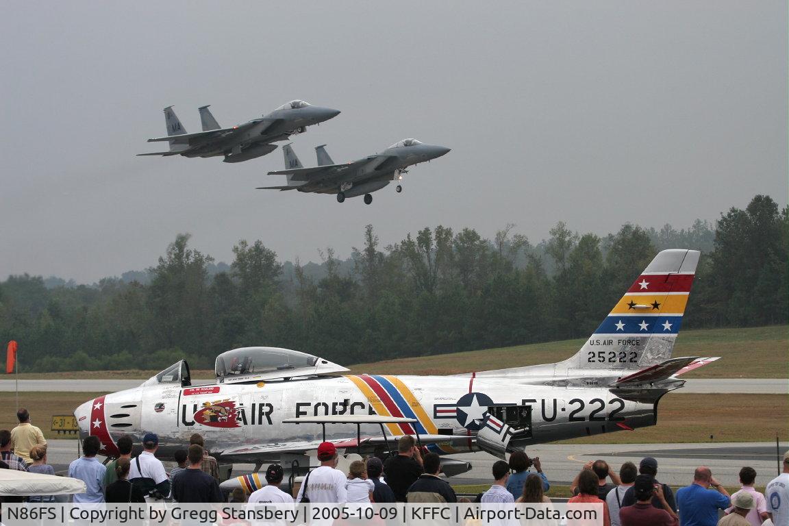 N86FS, 1954 Canadair F-86 MK.5 Sabre C/N 1157, A pair of Eagles make a low pass down the runway while Wyatt Fuller's F-86 is resting between flights.