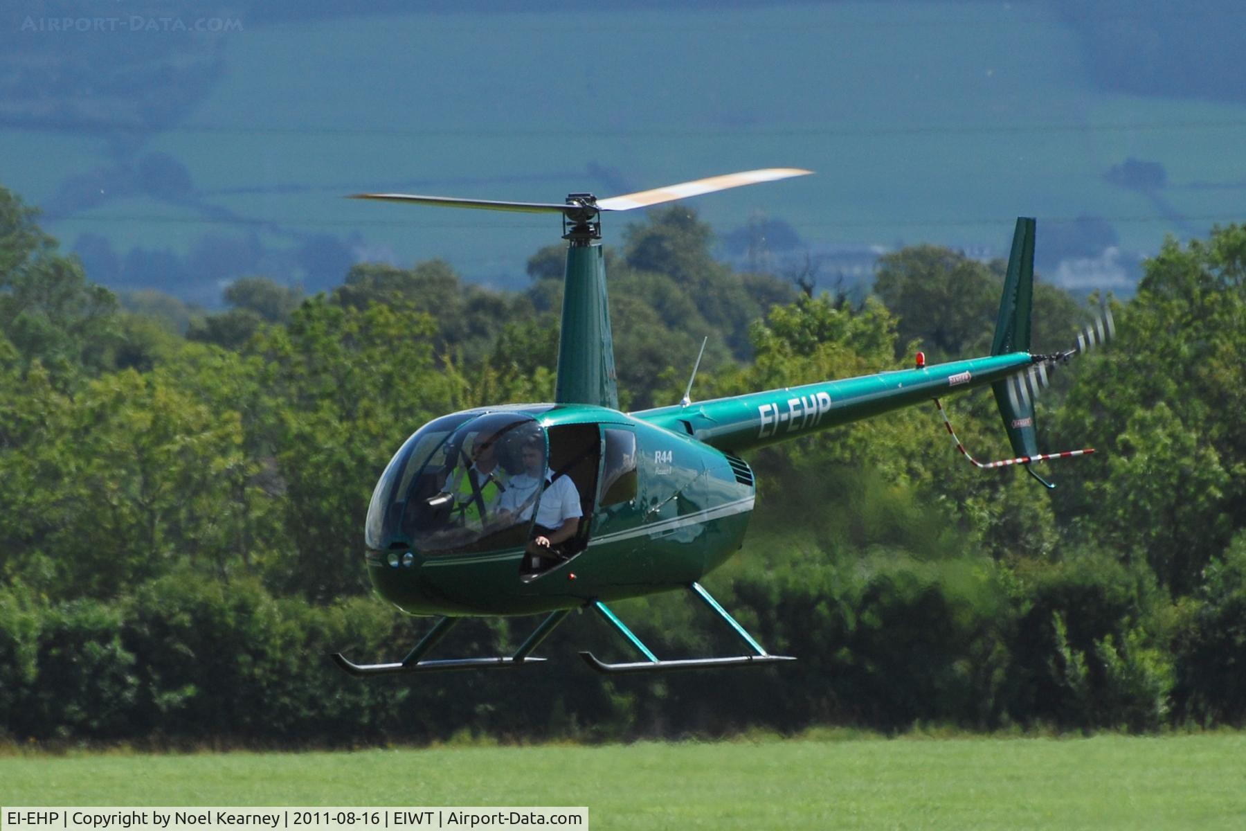 EI-EHP, Robinson R44 Raven II C/N 1913, Air-taxi onto stand at Weston.