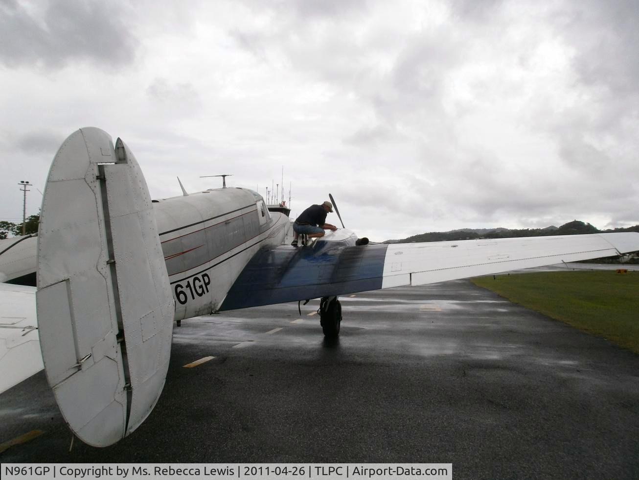 N961GP, 1961 Beech-Hamilton G18S Westwind III C/N BA-559, Checking the oil after freight delivery to St Lucia, Caribbean.
