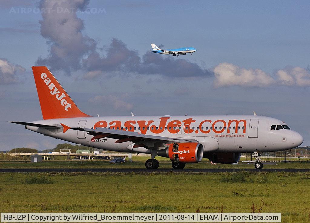 HB-JZP, 2005 Airbus A319-111 C/N 2427, Roll out on 18R,
in the back KLM Boeing 747-406 on final approach
to runway 18C.