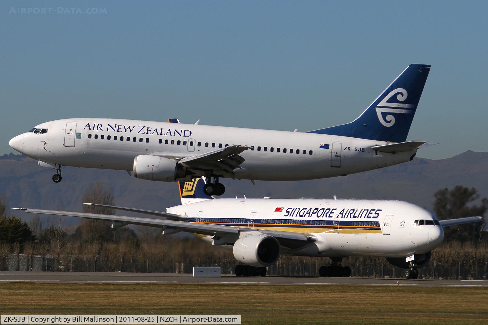ZK-SJB, 1997 Boeing 737-33R C/N 28868, and SQ298 (9V-SRN) waits