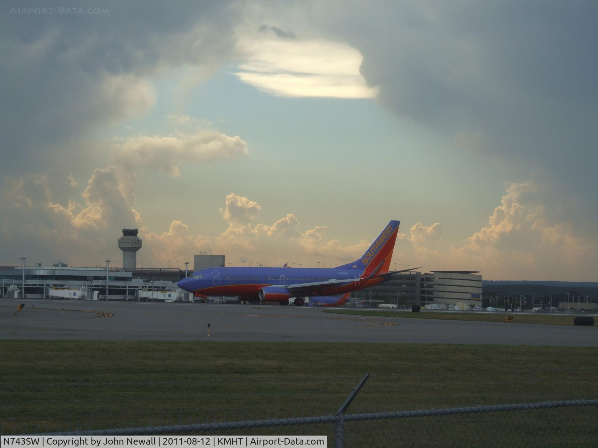 N743SW, 1998 Boeing 737-7H4 C/N 29279, Interesting cloud formations that day. Shot at MHT on runway 17.