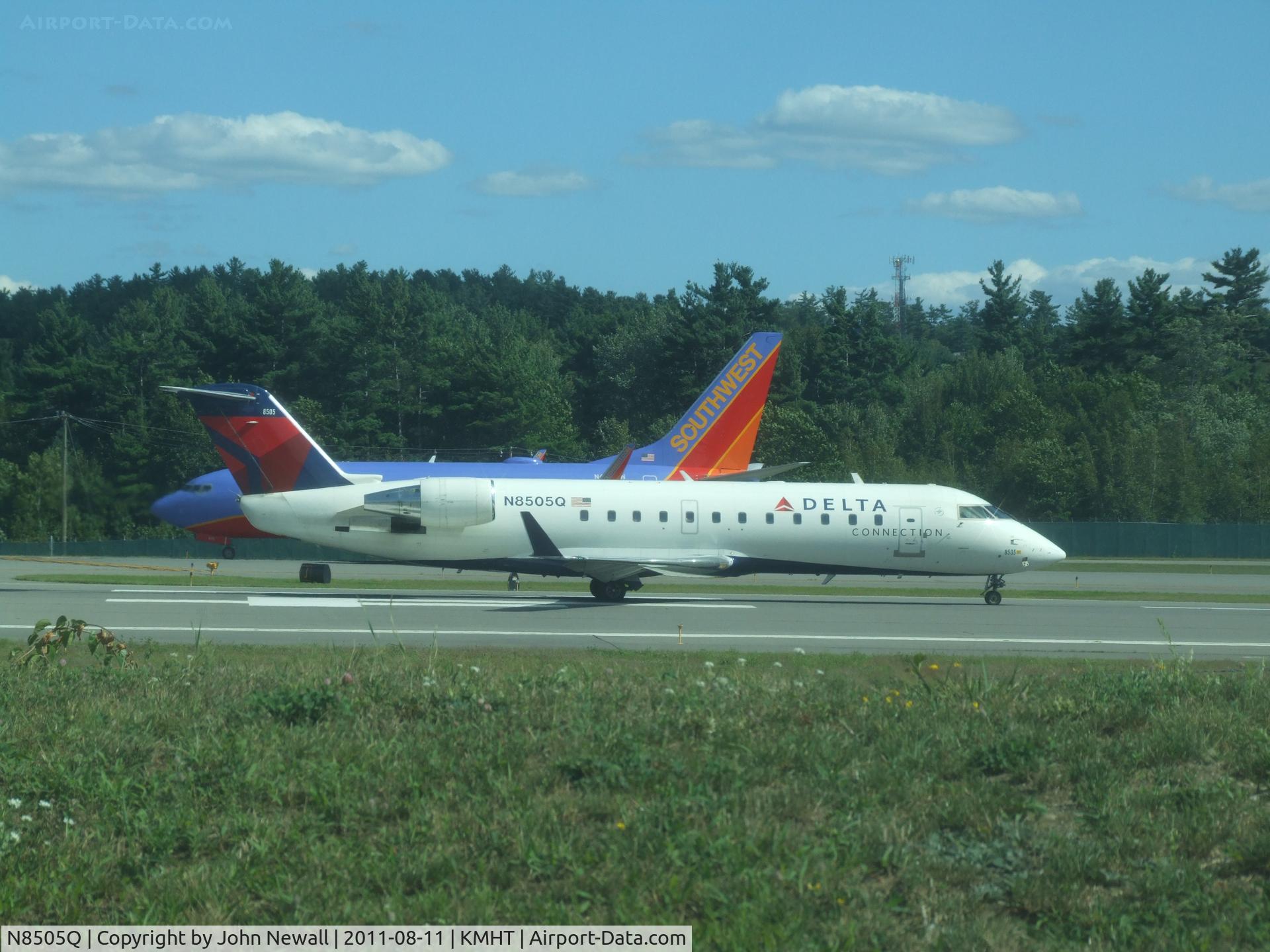 N8505Q, 2001 Bombardier CRJ-200LR (CL-600-2B19) C/N 7505, ready to start take-off roll on runway 24. N435WN, a Southwest 737-7H4 awaiting take off on taxiway Juliet behind.