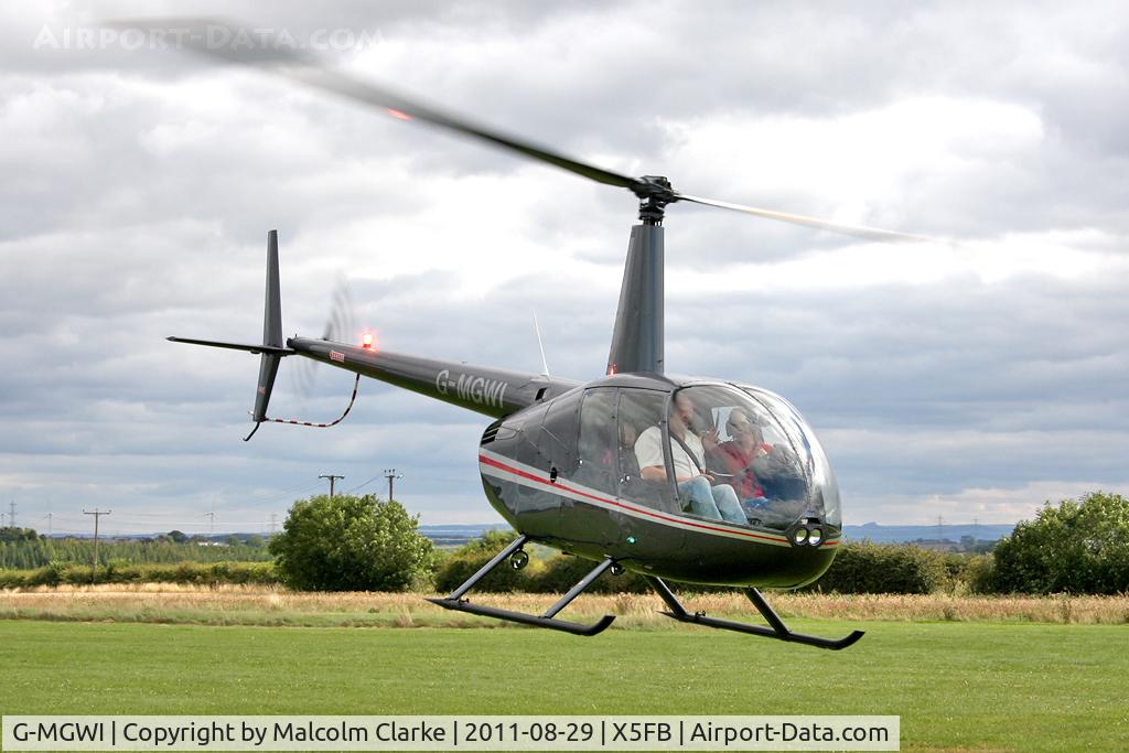 G-MGWI, 2000 Robinson R44 Astro C/N 0663, Robinson R44 Astro at Fishburn Airfield, UK, August 2011.