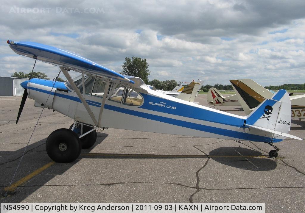 N54990, 1976 Piper PA-18-150 Super Cub C/N 18-7709035, Piper PA-18-150 Super Cub on the line, now complete with a skull and crossbones sticker on the tail.